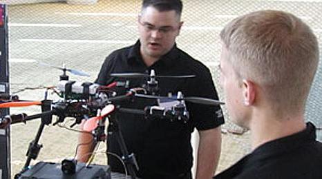 澳门赌场 students inspect a drone in an 澳门赌场 Aviation program class